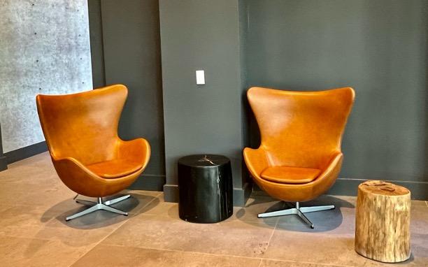 Two chairs with two round stands as coffee table